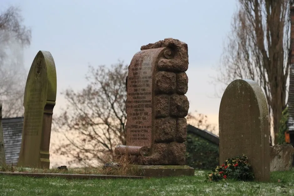 Weathered historic gravestones at dusk in an old cemetery, illustrative of endangered sites needing preservation